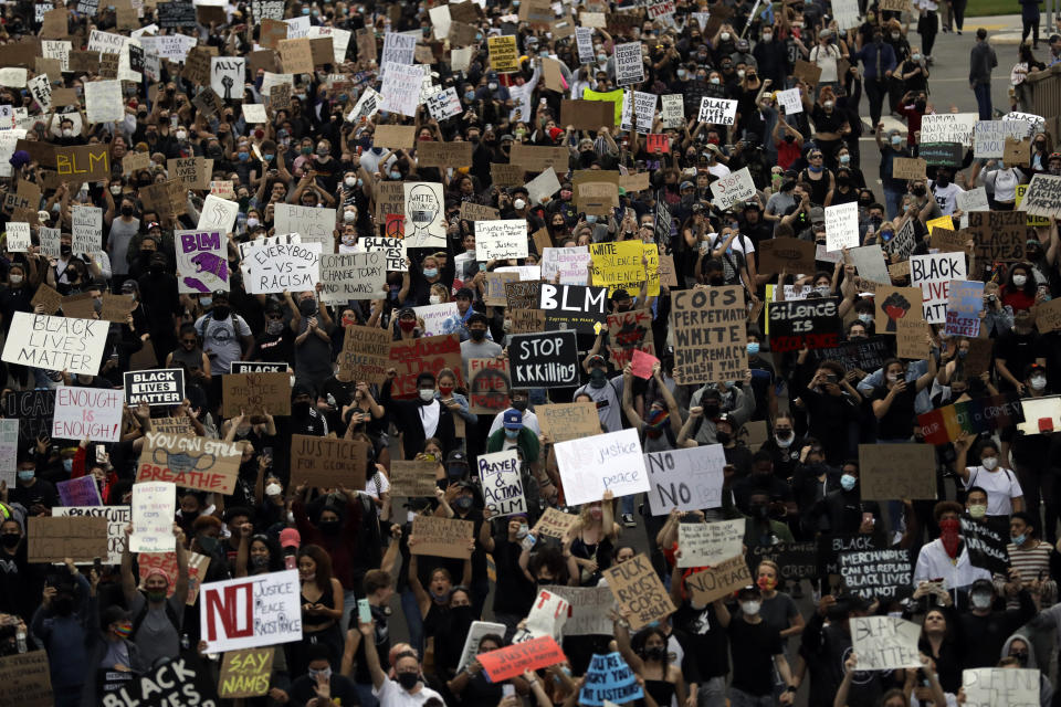 Protesters march Thursday, June 4, 2020, in San Diego. Protests continue to be held in U.S. cities, sparked by the death of George Floyd, a black man who died after being restrained by Minneapolis police officers on May 25. (AP Photo/Gregory Bull)