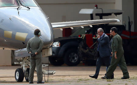 Former speaker of Brazil's Lower House of Congress, Eduardo Cunha (2nd L), is escorted by federal police during their transfer to Curitiba, in the hangar of the Federal Police in Brasilia, Brazil, October 19, 2016. REUTERS/Adriano Machado