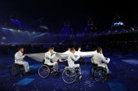 LONDON, ENGLAND - AUGUST 29: The Paralympic flag is carried by members of the Great Britain U22 Wheelchair basketball team during the Opening Ceremony of the London 2012 Paralympics at the Olympic Stadium on August 29, 2012 in London, England. (Photo by Dan Kitwood/Getty Images)