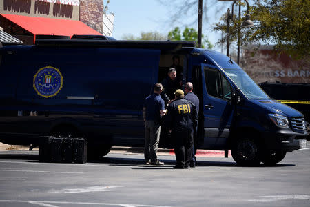 Law enforcement personnel are seen outside a FedEx Store which was closed for investigation, in Austin, Texas, U.S., March 20, 2018. REUTERS/Sergio Flores