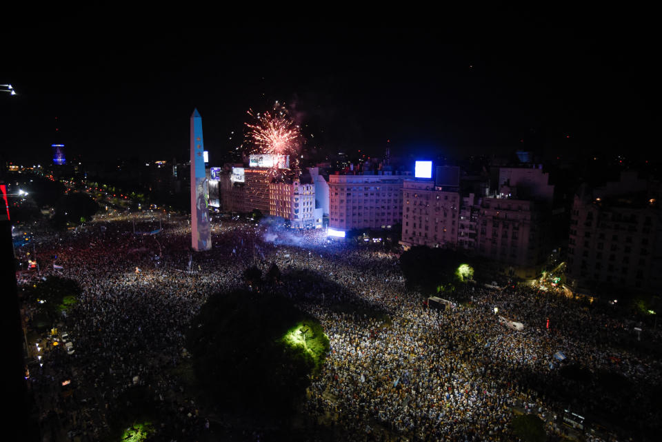 Soccer Football - FIFA World Cup Final Qatar 2022 - Fans in Buenos Aires - Buenos Aires, Argentina - December 18, 2022  Argentina fans celebrate winning the World Cup at the Obelisk with fireworks REUTERS/Mariana Nedelcu