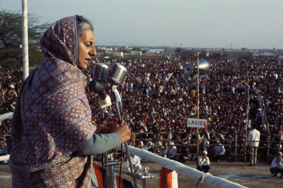 Indira Gandhi speaks into microphone to crowd