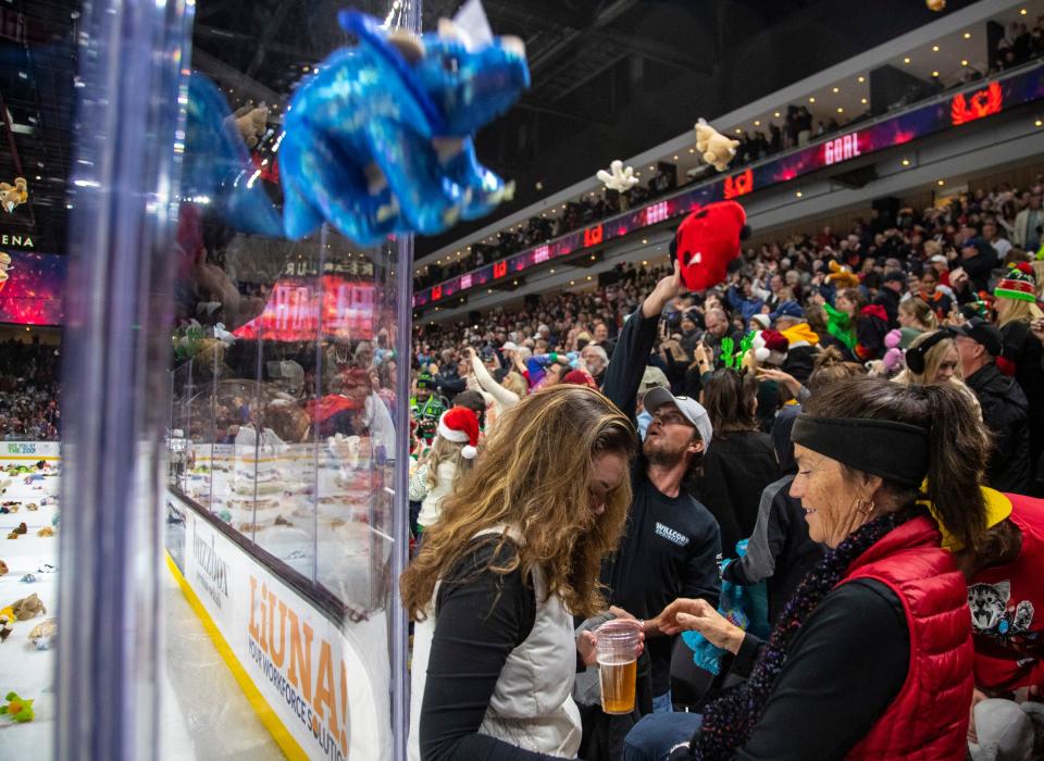 Fans throw teddy bears and other stuffed animals onto the ice after the first and only goal of the night by the Coachella Valley Firebirds during the third period of their game at Acrisure Arena in Palm Desert, Calif., Friday, Dec. 23, 2022. 