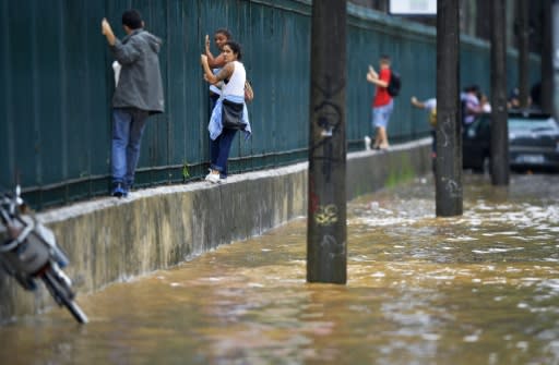 Watch out - caimans may be lurking in that flooded Rio de Janeiro road