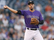 FILE - In this Sept. 12, 2018, file photo, Colorado Rockies third baseman Nolan Arenado throws to first base to put out Arizona Diamondbacks' A.J. Pollock in the first inning of a baseball game in Denver. AL MVP Mookie Betts, NL Cy Young Award winner Jacob deGrom and major league home run champion Khris Davis reached high-priced one-year deals to avoid salary arbitration, while Arenado and pitchers Gerrit Cole, Luis Severino and Aaron Nola failed to reach agreements and for now appeared headed to hearings. (AP Photo/David Zalubowski, File)