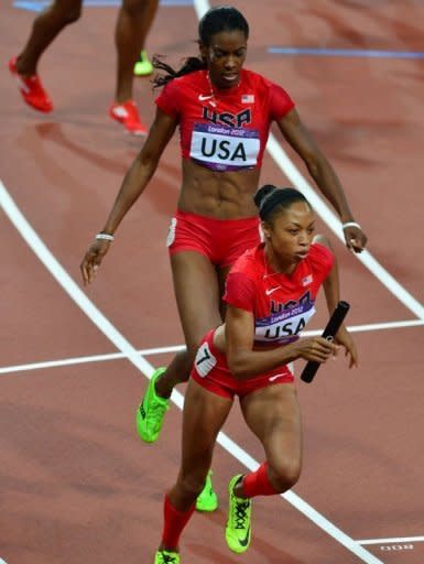 USA's Deedee Trotter (L) hands off to Allyson Felix during the women's 4X400 relay final at the athletics event of the London 2012 Olympic Games. The USA won gold