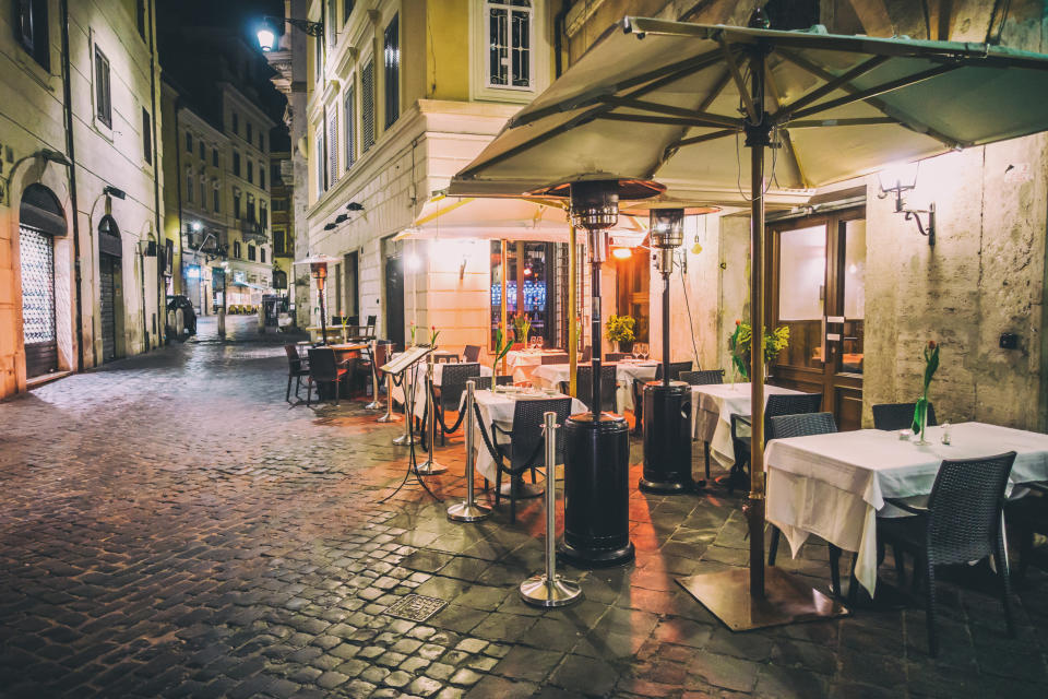 empty restaurant tables in the street of Rome. Italy