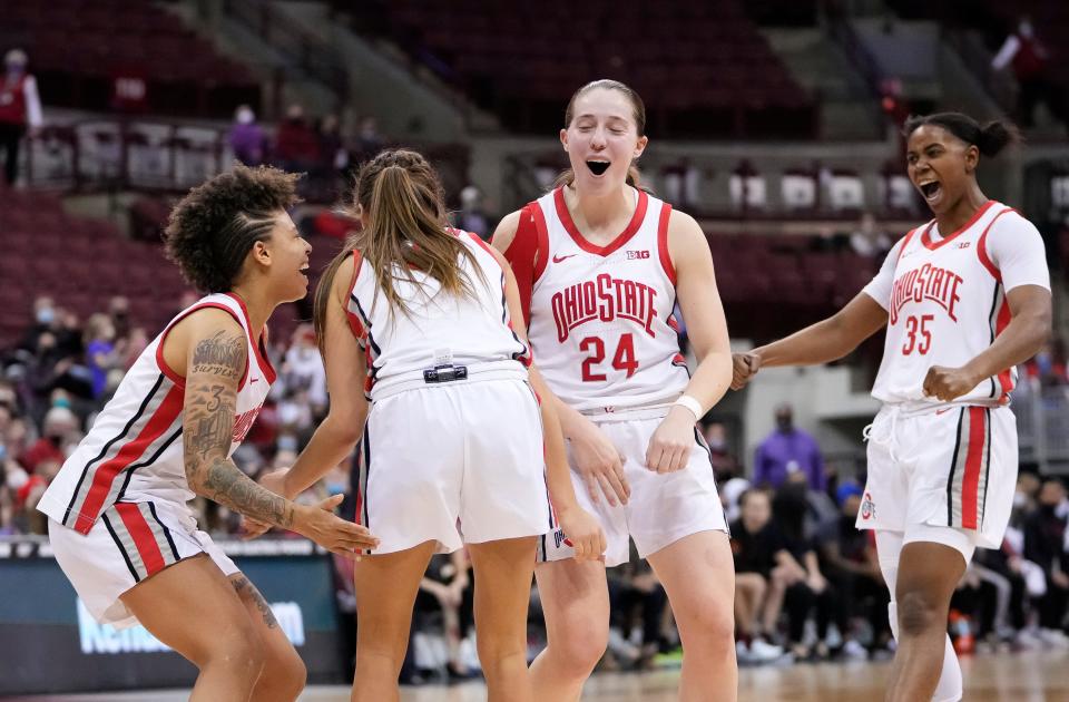 Ohio State Buckeyes guard Rikki Harris (1), guard Taylor Mikesell (24) and forward Tanaya Beacham (35) celebrate the 1,000th point by guard Jacy Sheldon (4) during the fourth quarter of the NCAA women's basketball game against the Maryland Terrapinsat Value City Arena in Columbus on Thursday, Jan. 20, 2022. Ohio State won 95-89.