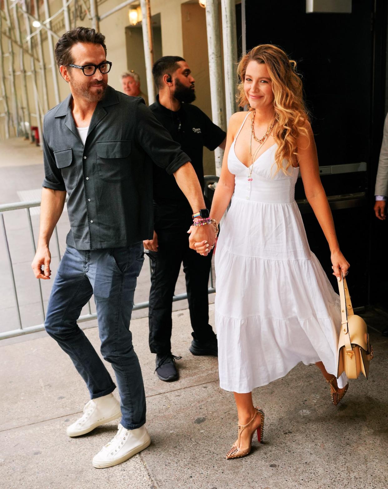 Ryan Reynolds and Blake Lively hold hands as they exit a hotel.