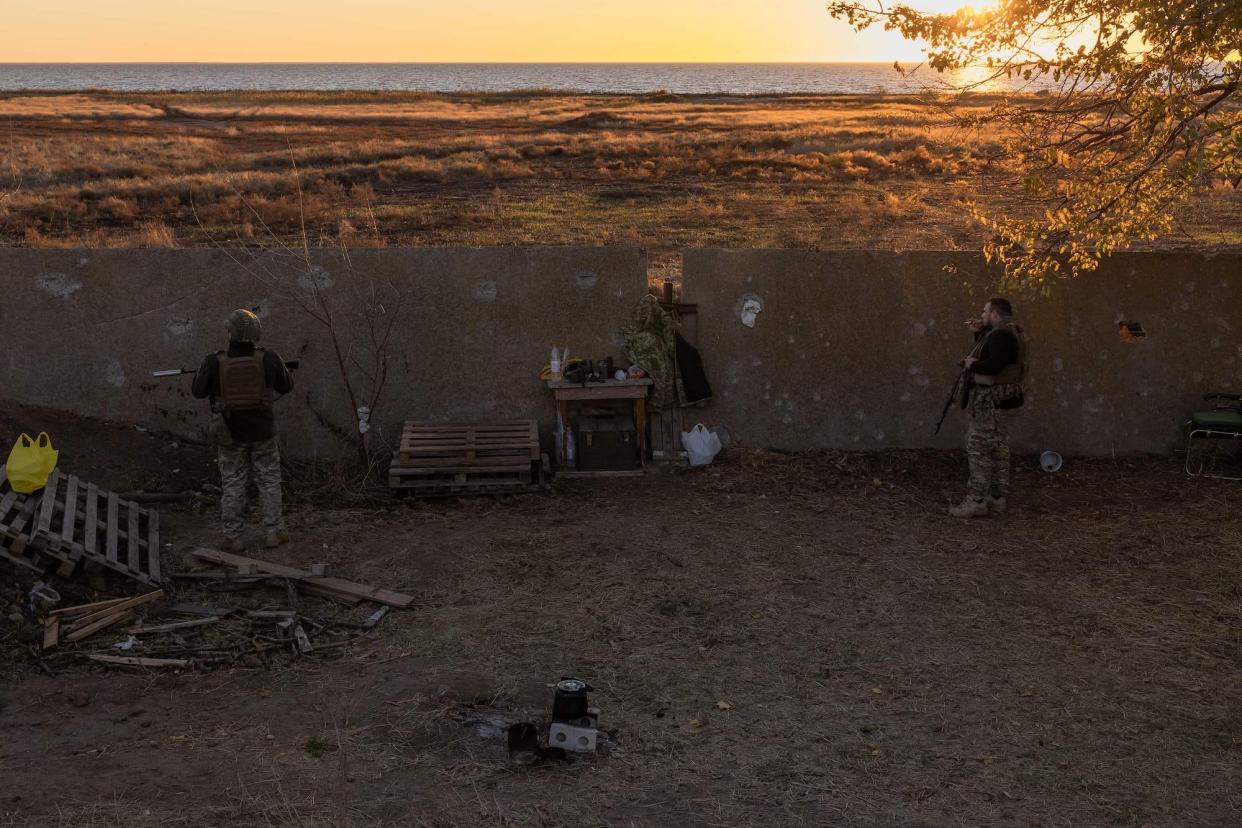 Three Ukrainian servicemen of the 123rd Territorial Defense Brigade next to the Dnipro River