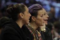 Basketball player Diana Taurasi, soccer player Megan Rapinoe and basketball player Sue Bird, from left, are seen during the second half of the NBA All-Star basketball game Sunday, Feb. 16, 2020, in Chicago. (AP Photo/Nam Huh)