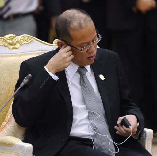 Philippines President Benigno Aquino puts on an earphone at the 20th summit of the Association of Southeast Asian Nations (ASEAN) in Phnom Penh on April 4, 2012. Tensions with China over disputed islands in the potentially resource-rich South China Sea -- a strategic international shipping lane -- have been the most difficult issue for Southeast Asian leaders, diplomats said