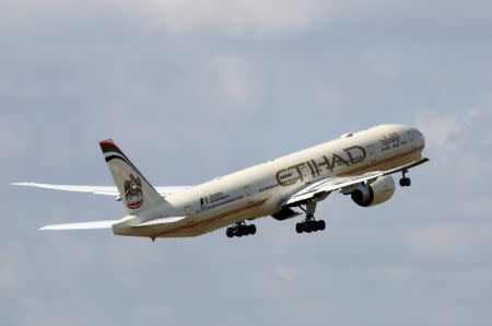 An Etihad Airways Boeing 777-3FX company aircraft takes off at the Charles de Gaulle airport in Roissy, France, August 9, 2016. REUTERS/Jacky Naegelen