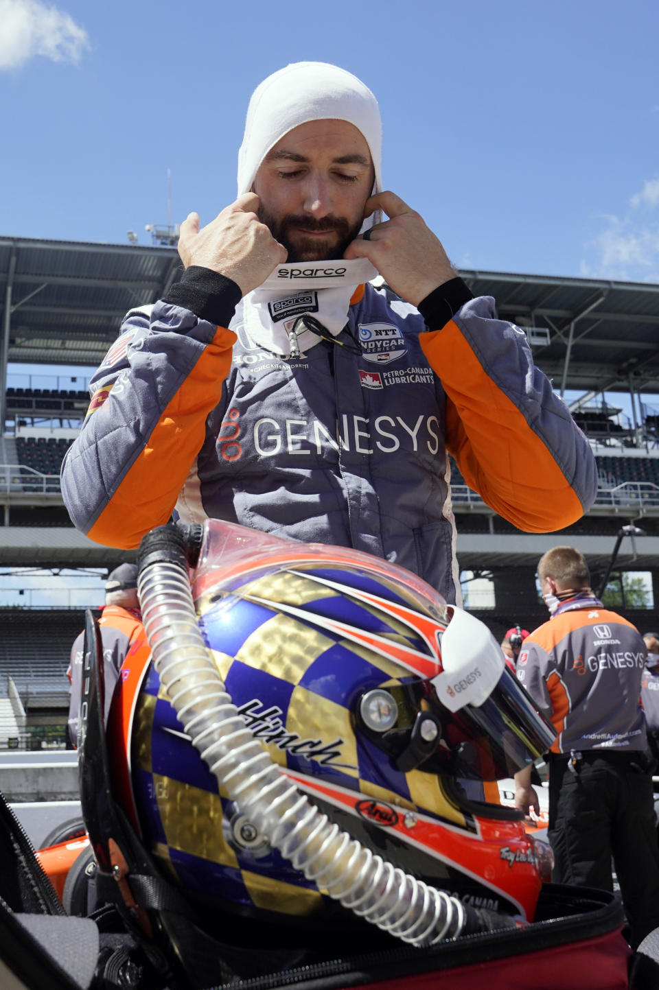 FILE- In this Aug. 16, 2020, file photo, James Hinchcliffe, of Canada, takes off his balaclava after qualifying for the Indianapolis 500 auto race at the Indianapolis Motor Speedway in Indianapolis. Hinchcliffe will return to Andretti Autosport for the final three races of the season to fill the seat left vacant when Zach Veach stepped out of the car earlier this week, Andretti Autosport announced Friday, Sept. 25, 2020. (AP Photo/Darron Cummings, File)