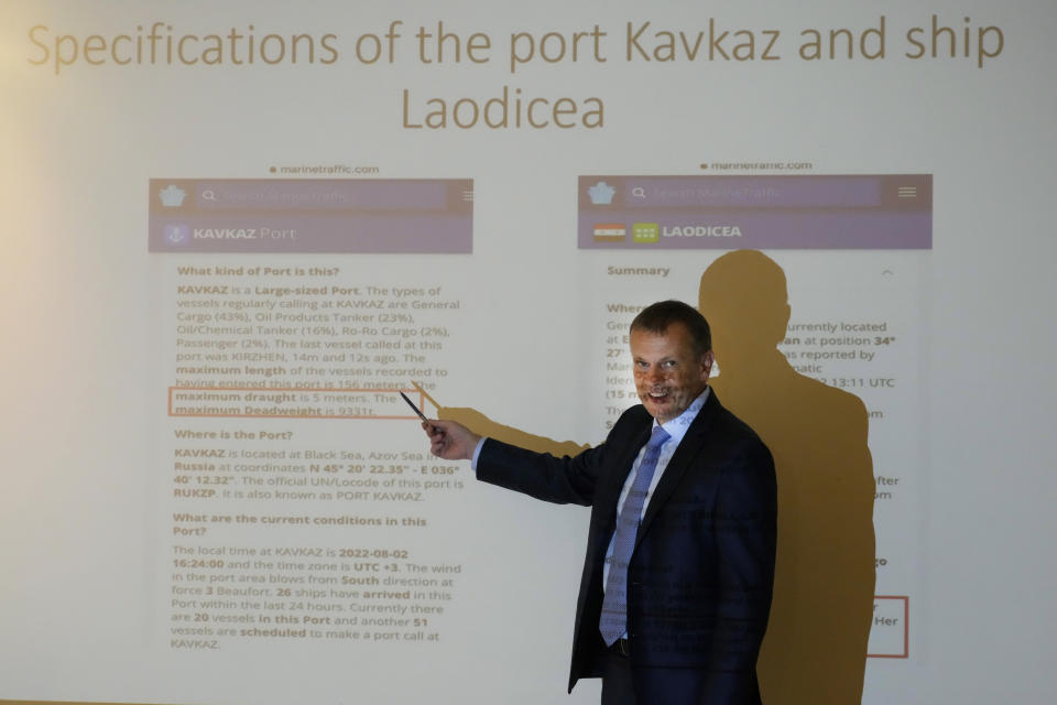 A Ukrainian embassy official, displays documents to journalists about a Syrian ship docked in a Lebanese port he says is carrying Ukrainian grain stolen by Russia, during a press conference, in Beirut, Lebanon, Wednesday, Aug. 3, 2022. The Ukrainian ambassador to Beirut Ihor Ostash, insisted Tuesday that a Syrian ship docked in Lebanon is carrying stolen Ukrainian grain, days before the cash-strapped country receives Ukraine's first grain shipment since Russia's invasion began over five months ago. (AP Photo/Hussein Malla)