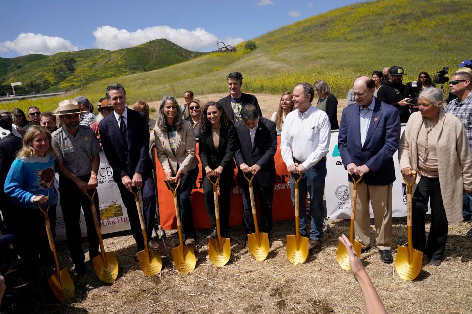 California Gov. Gavin Newsom, third from left, joins other dignitaries during a ground breaking ceremony for the Wallis Annenberg Wildlife Crossing Friday, April 22, 2022, in Agoura Hills, Calif. Construction has begun on what's billed as the world's largest wildlife crossing for mountain lions and other animals caught in Southern California's urban sprawl.
