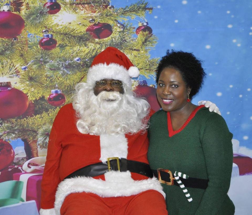 The Gift of Life Foundation volunteer Chester Mallory waits to greet kids with Christmas event organizer Mona Taylor-Davis in 2018.