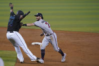 Atlanta Braves shortstop Dansby Swanson (7) runs down Miami Marlins' Jesus Aguilar (24) during a double play in the third inning of a baseball game, Saturday, June 12, 2021, in Miami. Marlins' Corey Dickerson was out at first. (AP Photo/Wilfredo Lee)