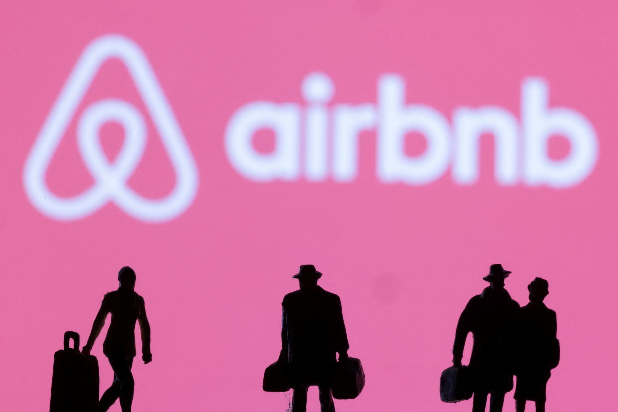 Figurines are seen in front of the Airbnb logo in this illustration taken February 27, 2022. REUTERS/Dado Ruvic/Illustration