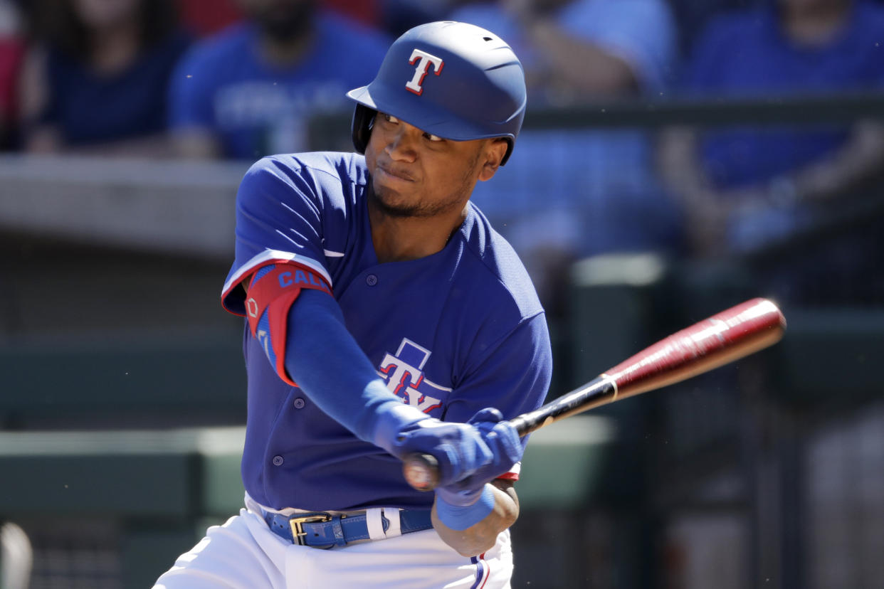 Texas Rangers' Willie Calhoun bats during the first inning of a spring training baseball game against the Chicago White Sox Saturday, Feb. 29, 2020, in Surprise, Ariz. (AP Photo/Charlie Riedel)