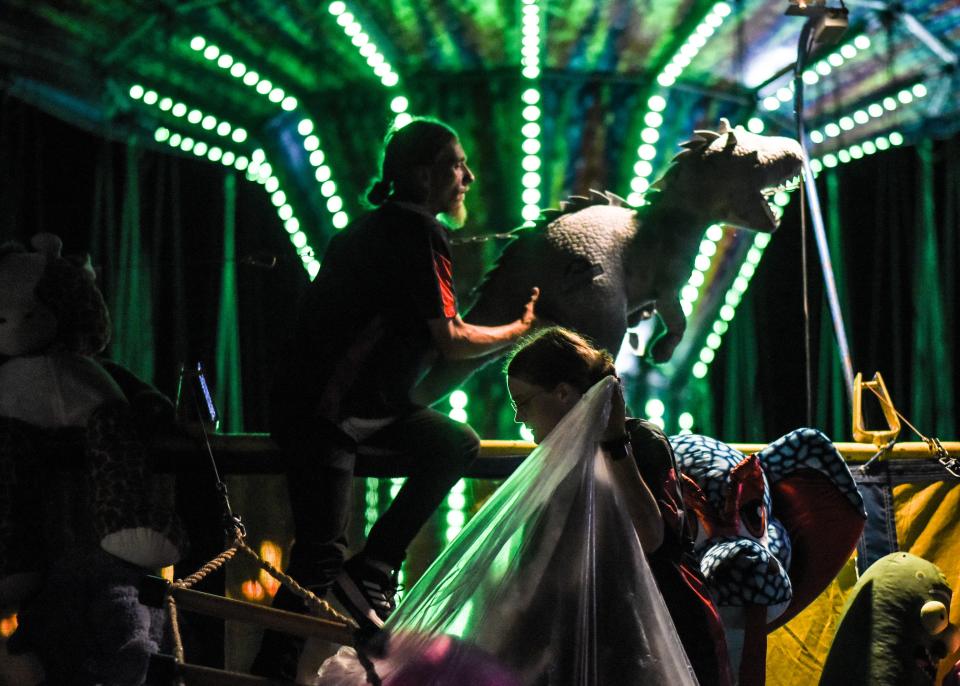 Stephen Stimpson, II, of Bangor, Maine, and his girlfriend Colleen DeMaris, 22, also of Bangor break down their Jacob's Ladder midway game late Friday, July 16, 2022, after the closing of the Eaton County Fair in Charlotte. They'll close down their game booth and later their fifth-wheel trailer and head to Hastings for the Barry County Fair. He is the second-generation of fair workers in his family. DeMaris works as a remote java programmer when not helping out on the midway.