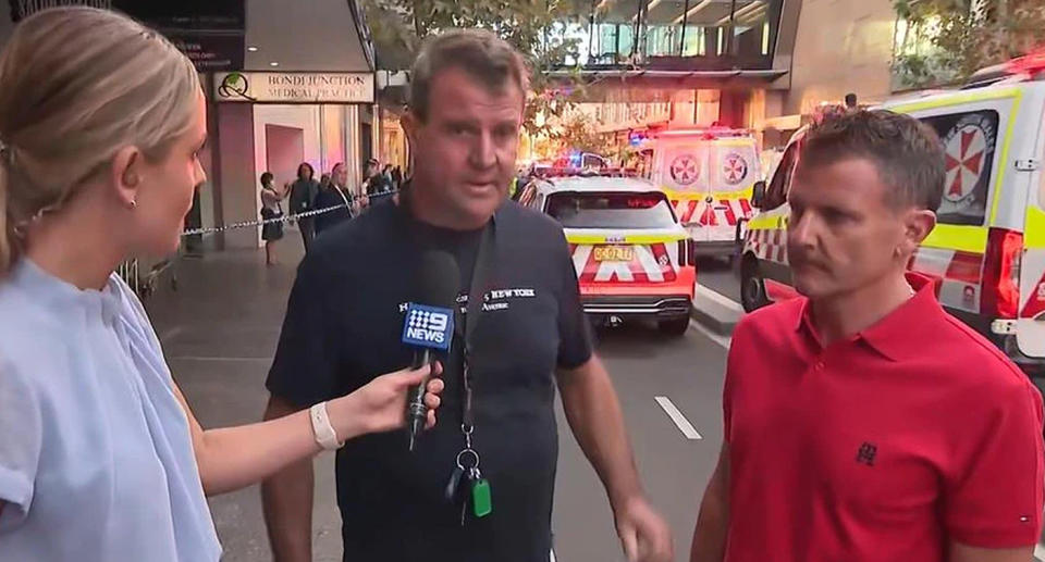 Two men who came came to the rescue of a mother and baby pictured outside Bondi Westfield speaking to media.