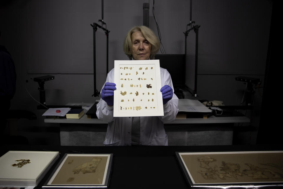 Israel Antiquities Authority conservator Tanya Bitler shows newly discovered Dead Sea Scroll fragments at the Dead Sea scrolls conservation lab in Jerusalem, Tuesday, March 16, 2021. Israeli archaeologists on Tuesday announced the discovery of dozens of new Dead Sea Scroll fragments bearing a biblical text found in a desert cave and believed hidden during a Jewish revolt against Rome nearly 1,900 years ago. (AP Photo/Sebastian Scheiner)