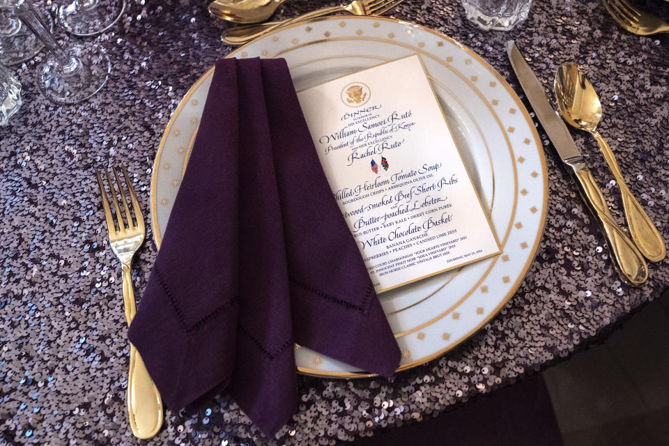 A place setting is seen atop a sequined tablecloth during a media preview, Wednesday, May 22, 2024, ahead of Thursday evening's State Dinner with Kenya's President William Ruto, at the White House in Washington. (AP Photo/Jacquelyn Martin)