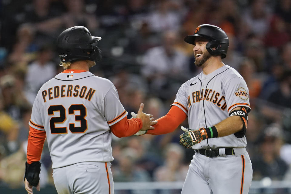 San Francisco Giants' Evan Longoria celebrates with Joc Pederson (23) after hitting a two-run home run against the Detroit Tigers in the sixth inning of a baseball game in Detroit, Tuesday, Aug. 23, 2022. (AP Photo/Paul Sancya)