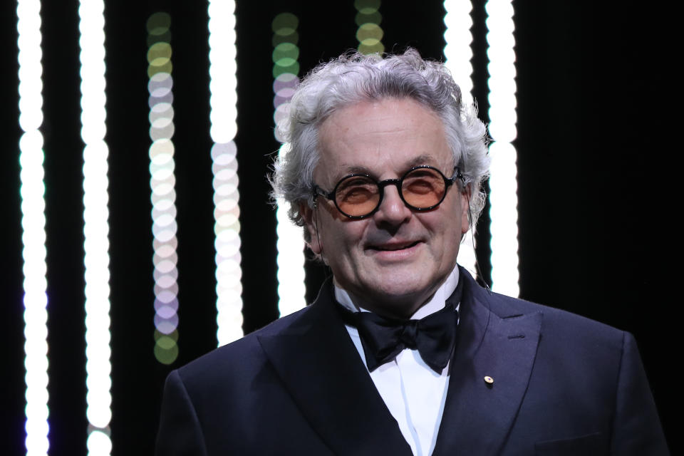 George Miller smiles as he arrives on stage on May 22, 2016 during the closing ceremony of the 69th Cannes Film Festival. (Credit: Valery Hache/AFP via Getty Images)