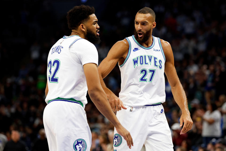 MINNEAPOLIS, MINNESOTA - MARCH 03: Rudy Gobert #27 interacrts with Karl-Anthony Towns #32 of the Minnesota Timberwolves in the first quarter against the LA Clippers at Target Center on March 03, 2024 in Minneapolis, Minnesota. NOTE TO USER: User expressly acknowledges and agrees that, by downloading and or using this photograph, User is consenting to the terms and conditions of the Getty Images License Agreement. (Photo by David Berding/Getty Images)