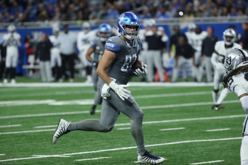 Lions tight end Sam LaPorta catches a touchdown pass against Raiders safety Tre'von Moehrig during the first half at Ford Field on Monday, Oct. 30, 2023.