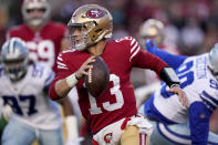 San Francisco 49ers quarterback Brock Purdy (13) rolls out against the Dallas Cowboys during the first half of an NFL divisional round playoff football game in Santa Clara, Calif., Sunday, Jan. 22, 2023. (AP Photo/Godofredo A. Vásquez)
