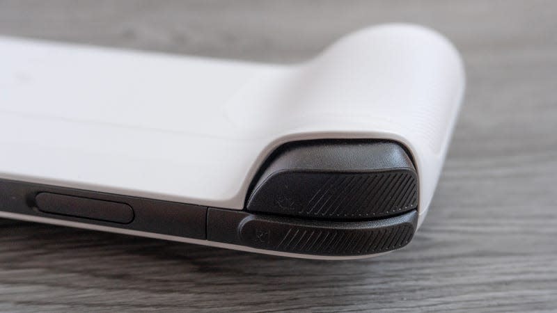 A close-up of the analog and digital shoulder buttons on the Logitech G Cloud against a gray wooden background.