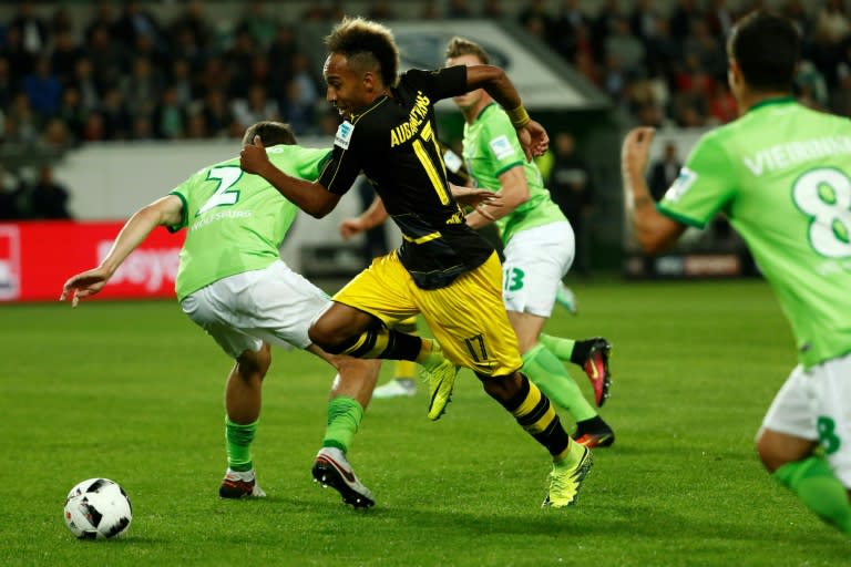 Dortmund's Gabonese forward Pierre-Emerick Aubameyang (C) and Wolfsburg's defender Philipp Wollscheid (L) vie for the ball during the German first division Bundesliga football match between VfL Wolfsburg and Borussia Dortmund