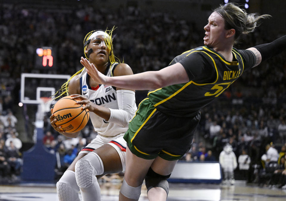UConn's Aaliyah Edwards, left, fouls Baylor's Caitlin Bickle (51) in the first half of a second-round college basketball game in the NCAA Tournament, Monday, March 20, 2023, in Storrs, Conn. (AP Photo/Jessica Hill)