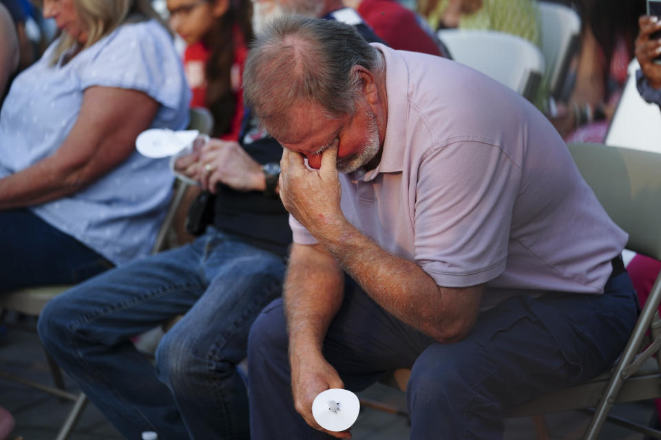 A man prays during a vigil for the victims of Saturday's mass shooting on Monday, July 17, 2023, in Hampton, Ga. (AP Photo/John Bazemore)