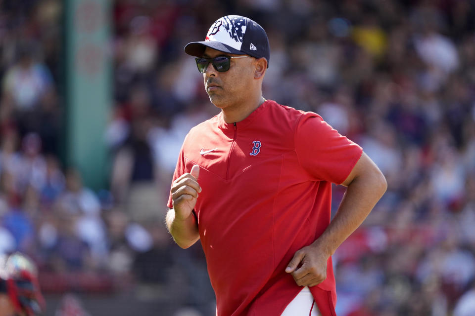 Boston Red Sox manager Alex Cora leaves the field after visiting the mound during the eighth inning of a baseball game against the Tampa Bay Rays at Fenway Park, Monday, July 4, 2022, in Boston. (AP Photo/Mary Schwalm)