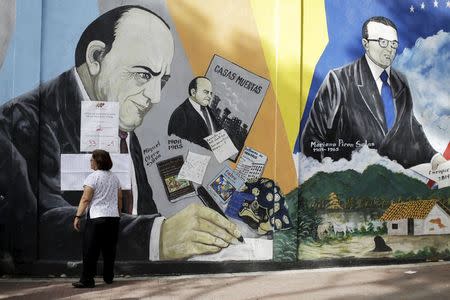 A woman searches for her name on a list outside a polling center in Caracas, June 28, 2015. REUTERS/Jorge Dan Lopez