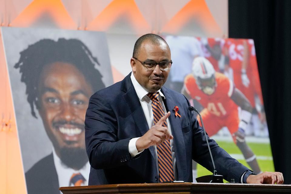 Virginia football coach Tony Elliott speaks during a memorial service for football players Lavel Davis Jr., D’Sean Perry and Devin Chandler at John Paul Jones Arena in Charlottesville, Va., Saturday, Nov. 19, 2022.