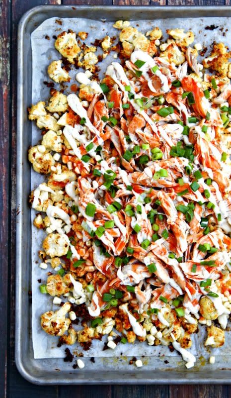 <p>The Wicked Noodle</p><p>This snack platter of nachos features roasted cauliflower with ranch dressing, fresh corn, shredded chicken and a hearty drizzle of buffalo sauce.</p><p><strong>Get the recipe: <a href="http://www.thewickednoodle.com/buffalo-ranch-roasted-cauliflower-nachos/" rel="nofollow noopener" target="_blank" data-ylk="slk:Buffalo Ranch Roasted Cauliflower Nachos;elm:context_link;itc:0;sec:content-canvas" class="link rapid-noclick-resp">Buffalo Ranch Roasted Cauliflower Nachos</a></strong></p>