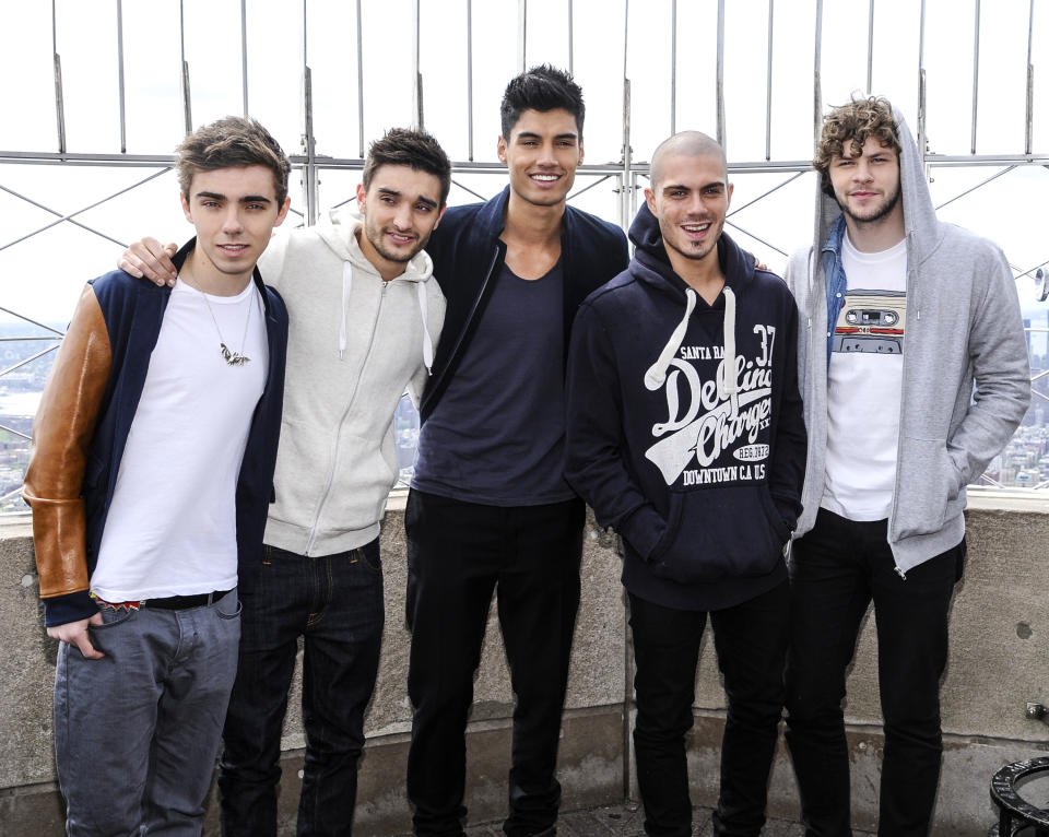 FILE - In this April 24, 2012 file photo, British boy band "The Wanted", from left, Nathan Sykes, Tom Parker, Siva Kaneswaran, Max George and Jay McGuiness visit the Empire State Building in New York. Being a boy band has somewhat haunted the British based-quintet since their formation in 2009: They had to change record labels after being told to learn how to dance. But coming to America _ and achieving some success _ is a dream come true for the group. After releasing two top 5 albums and five hit singles in Europe, they've now duplicated some of that in America with the party jam “Glad You Came,” which has spent eight weeks in the top 10 on Billboard's Hot 100 chart. (AP Photo/Evan Agostini, file)