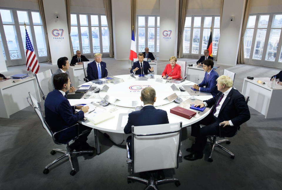 President of the European Council Donald Tusk, clockwise from center front, Italian Prime Minister Giuseppe Conte, Japan Prime Minister Shinzo Abe, U.S. President Donald Trump, President of France Emmanuel Macron, German Chancellor Angela Merkel, Canadian Prime Minister Justin Trudeau, and British Prime Minister Boris Johnson take part in a working session with G7 leaders on the second day of the G-7 summit in Biarritz, France Sunday, Aug. 25, 2019. (Sean Kilpatrick/The Canadian Press via AP)