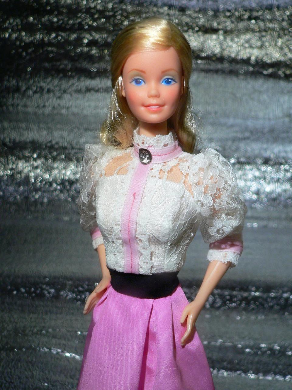 <p>In contrast, 1982's Angel Face Barbie has a much more subtle look, with a high-necked lace blouse accented with a cameo. </p><p><a href="https://flic.kr/p/B1EnQZ" rel="nofollow noopener" target="_blank" data-ylk="slk:Flickr photo by Julius Seelbach;elm:context_link;itc:0;sec:content-canvas" class="link "><em>Flickr photo by Julius Seelbach</em></a></p>