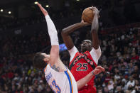 Toronto Raptors' Chris Boucher (right) shoots on Oklahoma City Thunder's Mike Muscala during the first half of an NBA basketball game Wednesday, Dec. 8, 2021, in Toronto. (Chris Young/The Canadian Press via AP)