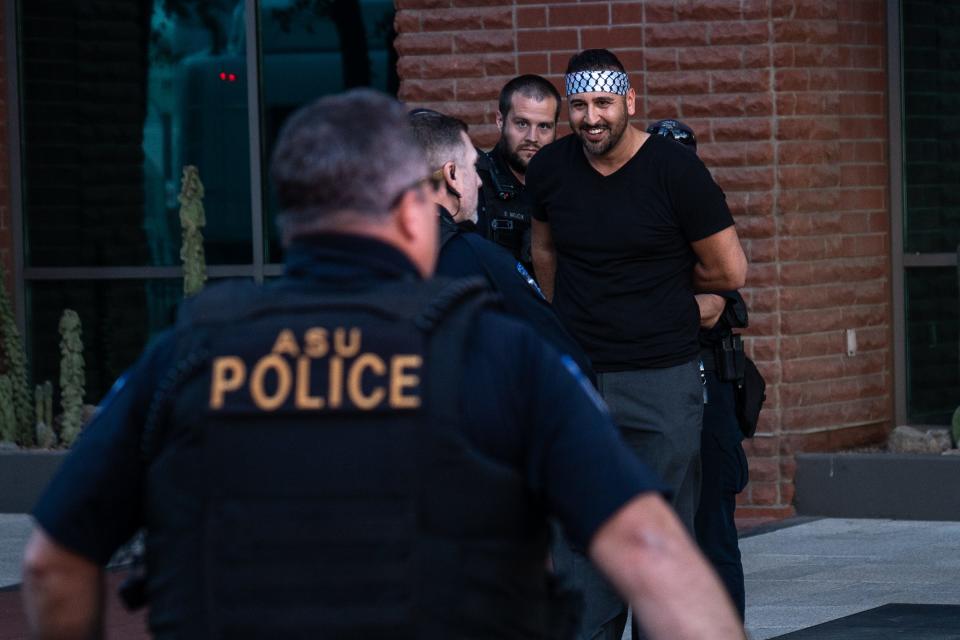 Tempe police officer detain a protestor near Arizona State University after the campus canceled an event where Congresswoman Rashida Tlaib was to speak on Palestine in Tempe on Nov. 17, 2023.