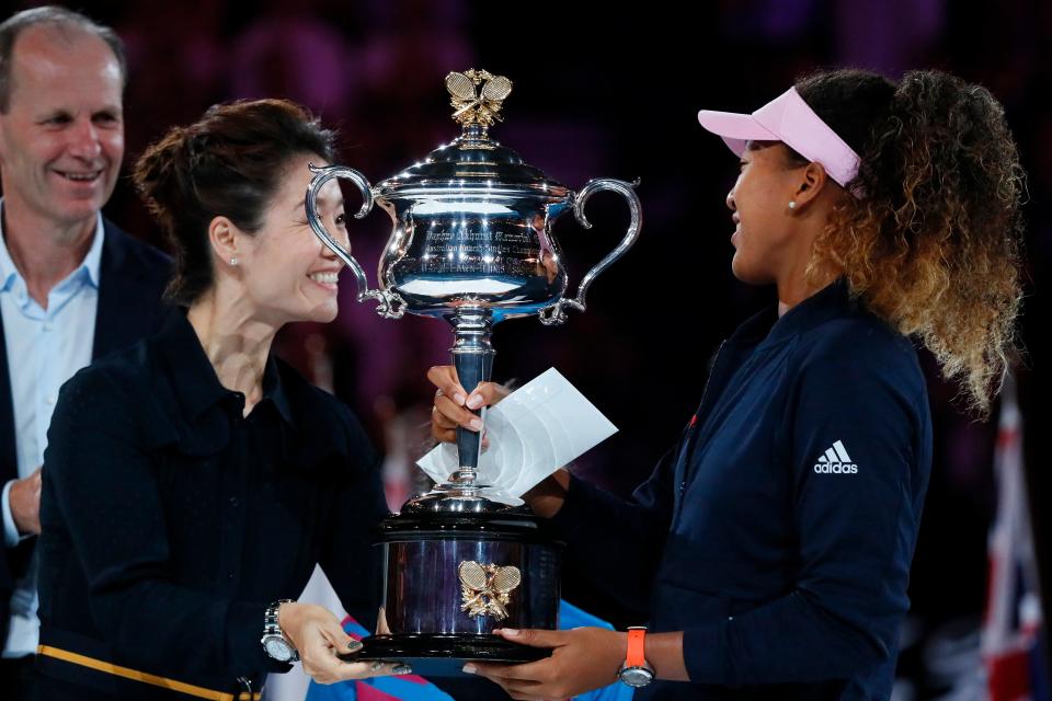 Naomi Osaka received the Australian Open championship trophy from Li Na after she won in 2019, five years after Na won. (DAVID GRAY/AFP via Getty Images)