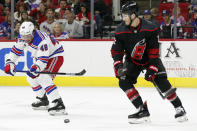 New York Rangers left wing Brendan Lemieux (48) passes the puck while Carolina Hurricanes defenseman Brett Pesce, right, defends during the first period of an NHL hockey game in Raleigh, N.C., Friday, Feb. 21, 2020. (AP Photo/Gerry Broome)