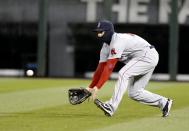 Boston Red Sox right fielder Daniel Nava makes a shoestring catch on a fly ball hit by Chicago White Sox's Marcus Semien during the seventh inning of a baseball game Tuesday, April 15, 2014, in Chicago. (AP Photo/Charles Rex Arbogast)