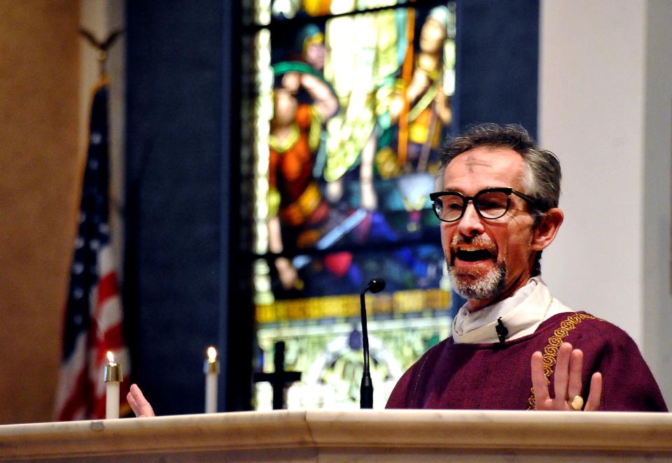 Father Stephen Moran gives an Ash Wednesday service at the Catholic church in Wooster.